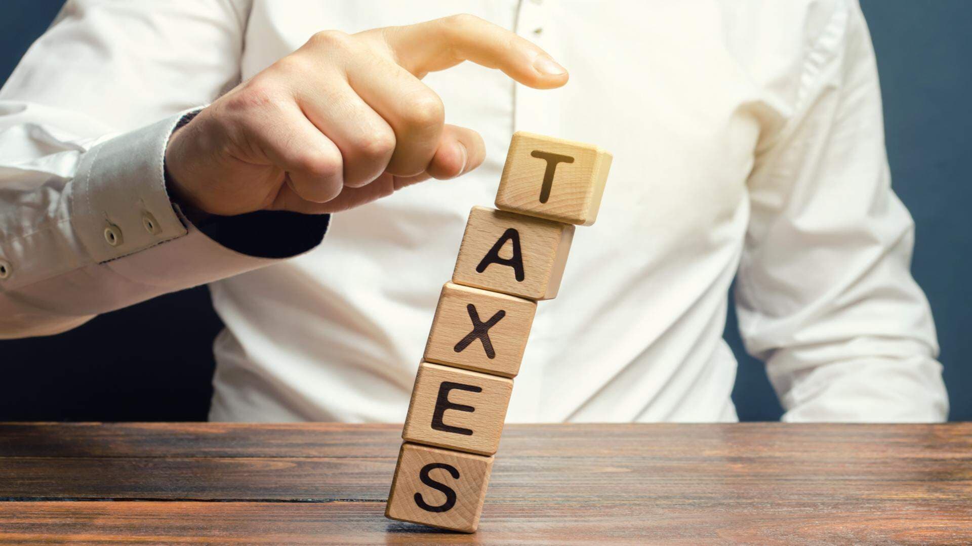 The word taxes in wooden blocks falling