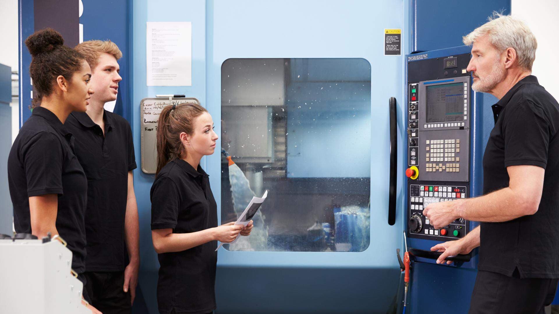13112869-three-apprentices-working-with-engineer-on-cnc-machinery (003).jpg