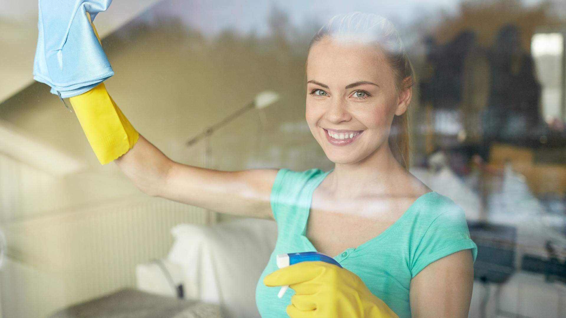 11201577-happy-woman-in-gloves-cleaning-window-with-rag.jpg
