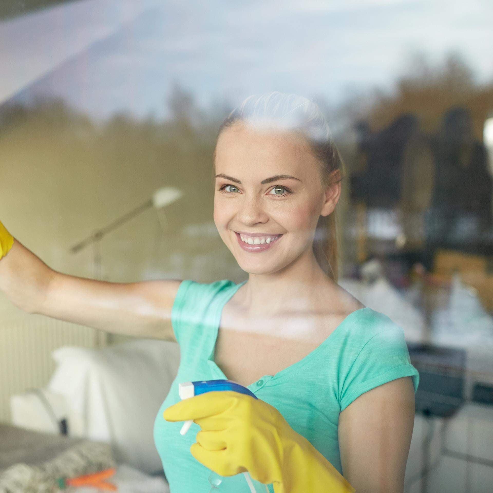 11201577-happy-woman-in-gloves-cleaning-window-with-rag.jpg