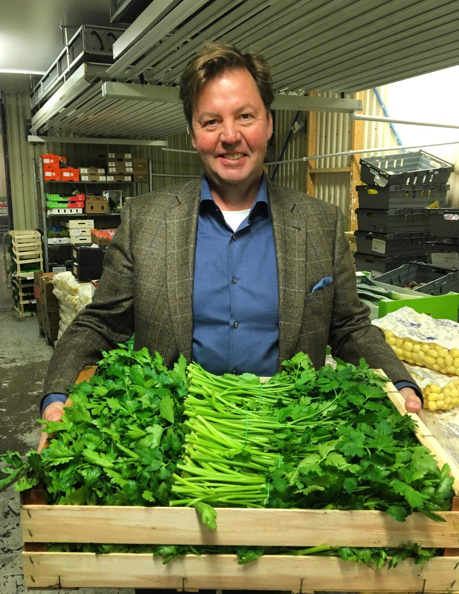 Lars Reinius håller i en låda med bladpersilja.