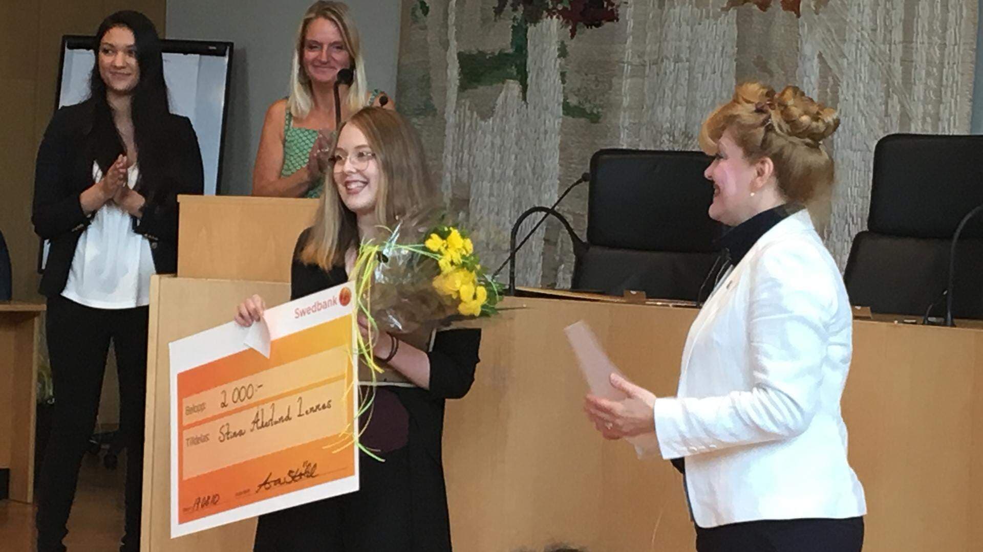 Stina Åkerlund Lennes tar emot sitt pris från Landshövding Minoo Akhtarzand,